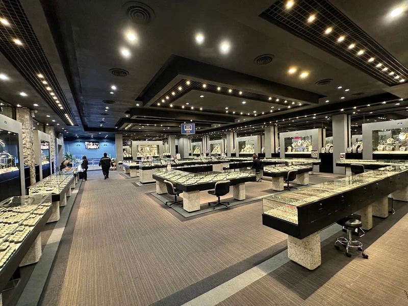 Vast Gems Gallery showroom floor with rows of lit display counters